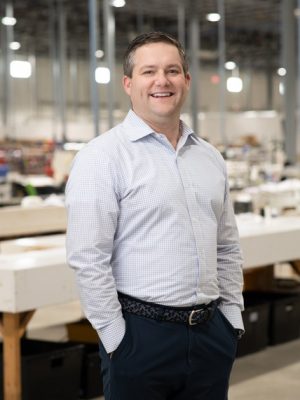 Moss inc employee environmental headshots in Franklin Park warehouse.